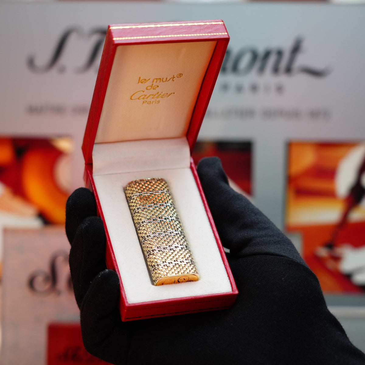 A gloved hand holds a rare collector's item: a vintage Cartier box containing a pre-owned Vintage 1980 Cartier Solid 18k Gold Basket Jacket, featuring the distinctive 750 hallmarks and crafted to perfection.