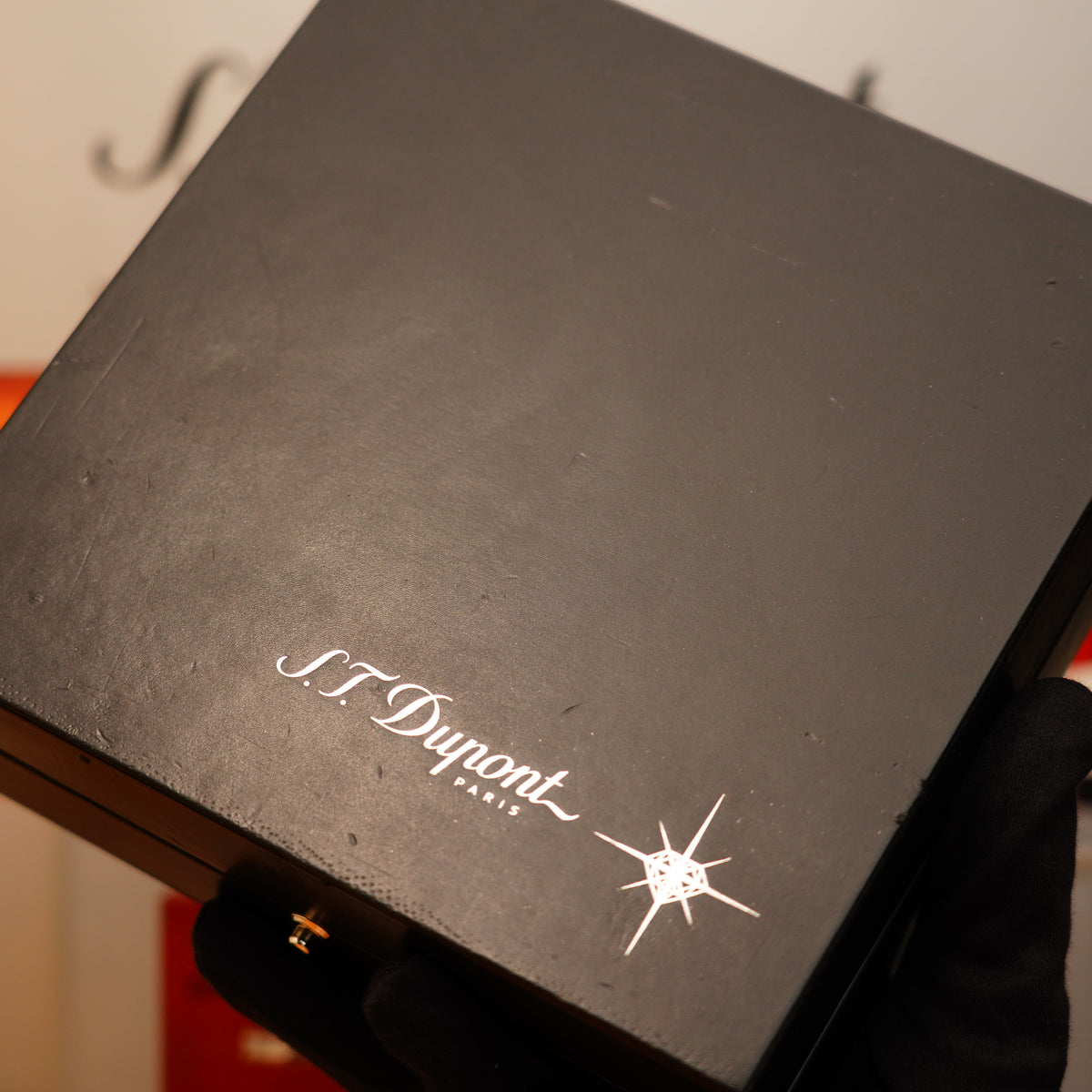 A gloved hand holds a black box featuring the S.T. Dupont logo in white on the lid, containing the Vintage 2005 St Dupont Diamond Drops with 22 Natural Diamond Heavy Platinum Limited Edition Large Ligne 2.