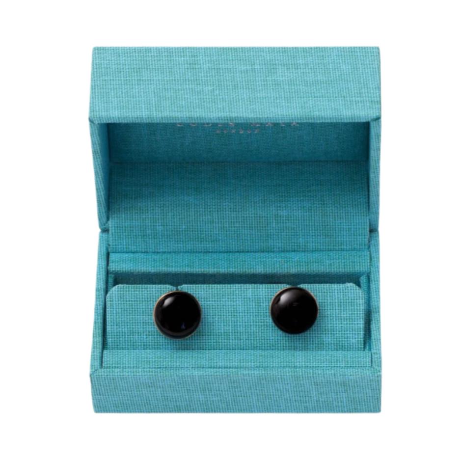 A pair of Onyx Stone Gold Capsule Cufflinks from KirbyAllison.com in a blue box.