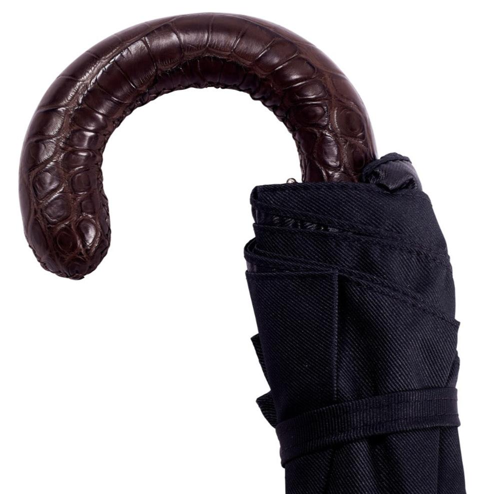 A KirbyAllison.com Brown Alligator Travel Umbrella with Black Canopy.