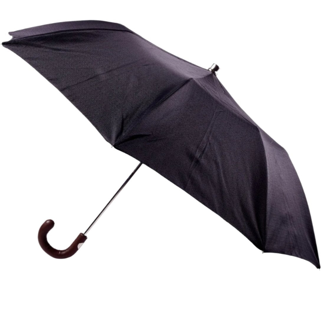 A Brown Pigskin Travel Umbrella with Black Canopy from KirbyAllison.com is open on a white background.