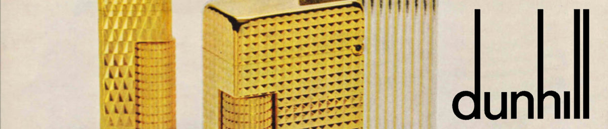 Close-up of two textured gold lighters next to the black "dunhill" logo on a light background.