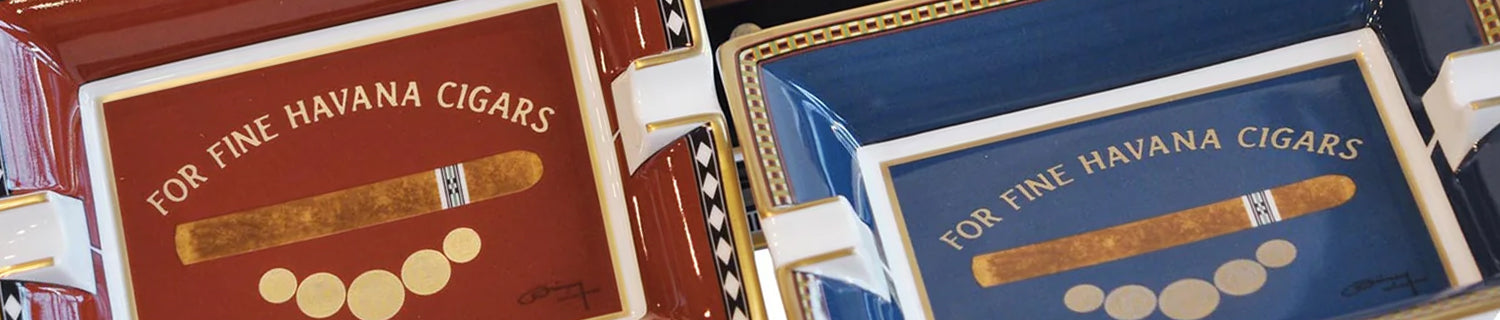 A red and black cigar box with decorative gold seals and inscriptions on the lid.