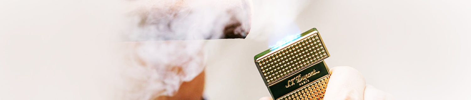 S.T. Dupont logo with "Paris" beneath, displayed on a blurred background.