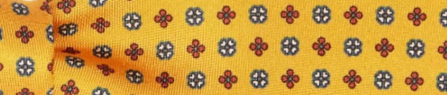 A pair of shoes and a brush on a table.