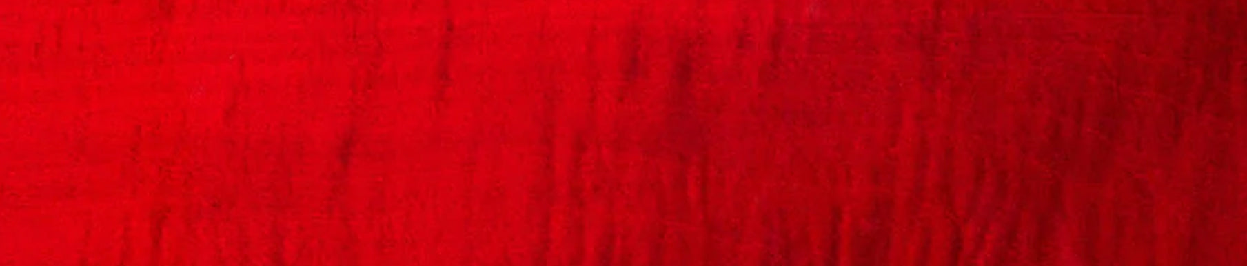 Red textured fabric surface with visible vertical and horizontal lines.
