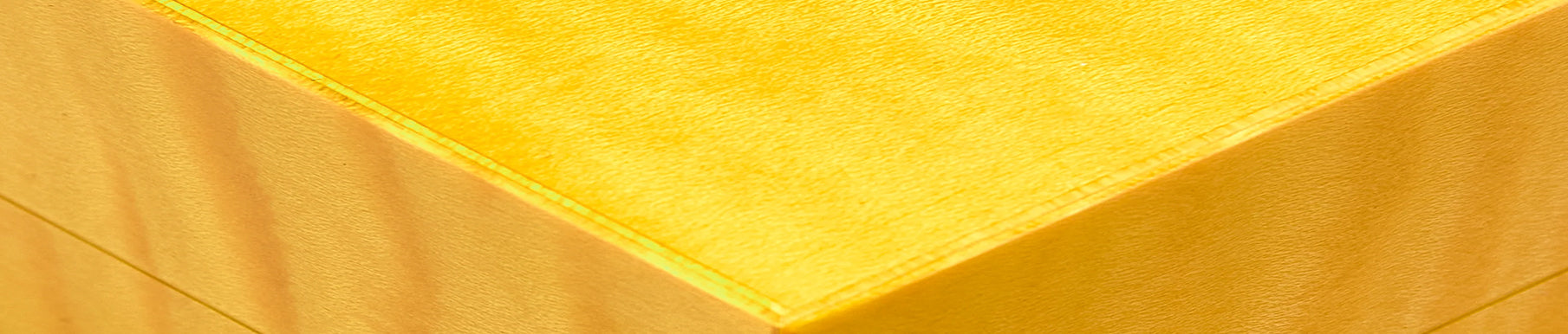 Red textured fabric surface with visible vertical and horizontal lines.