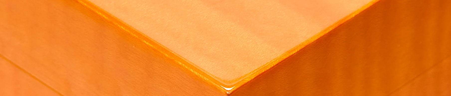 Red textured fabric surface with visible vertical and horizontal lines.