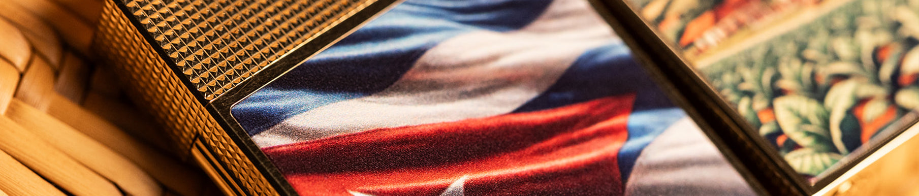 A close-up of a decorative box featuring an image of a wavy flag with red, white, and blue colors, bordered by gold and patterned surfaces.