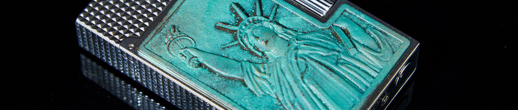 A close-up of a decorative box featuring an image of a wavy flag with red, white, and blue colors, bordered by gold and patterned surfaces.