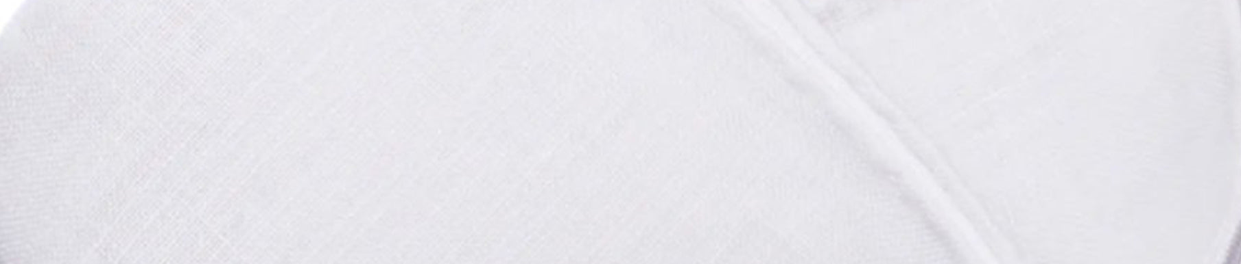 Close-up of a white textured fabric with a diagonal seam running across the right side.