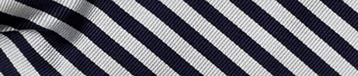 Close-up of fabric with diagonal navy and white stripes. The texture appears ribbed.