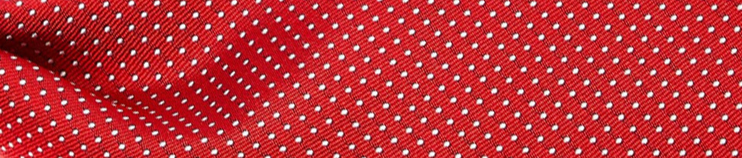 Red fabric with a pattern of small white polka dots.