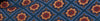 Geometric fabric pattern with blue diamond shapes and red floral centers, surrounded by beige motifs.