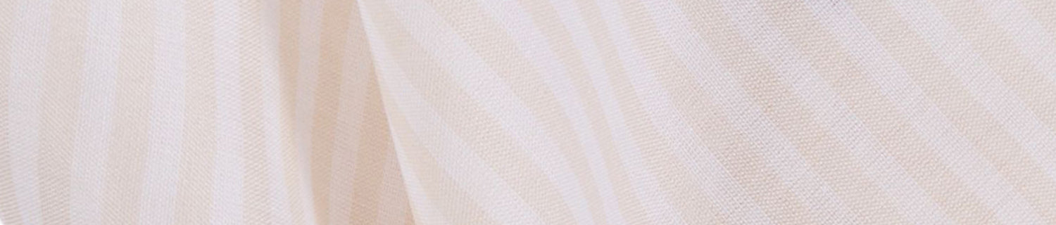 Close-up of beige and white striped fabric with a soft texture.