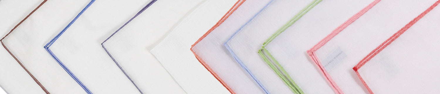 Four neatly arranged bedsheets with colored borders on a white background. Colors include purple, blue, and brown.