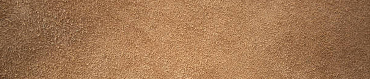 A pair of black shoes and a brush on a black surface.