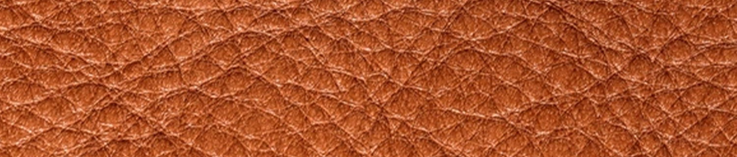 A pair of black shoes and a brush on a black surface.