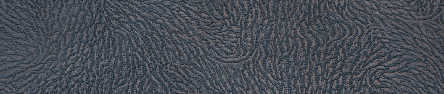 A pair of black shoes and a brush on a black surface.