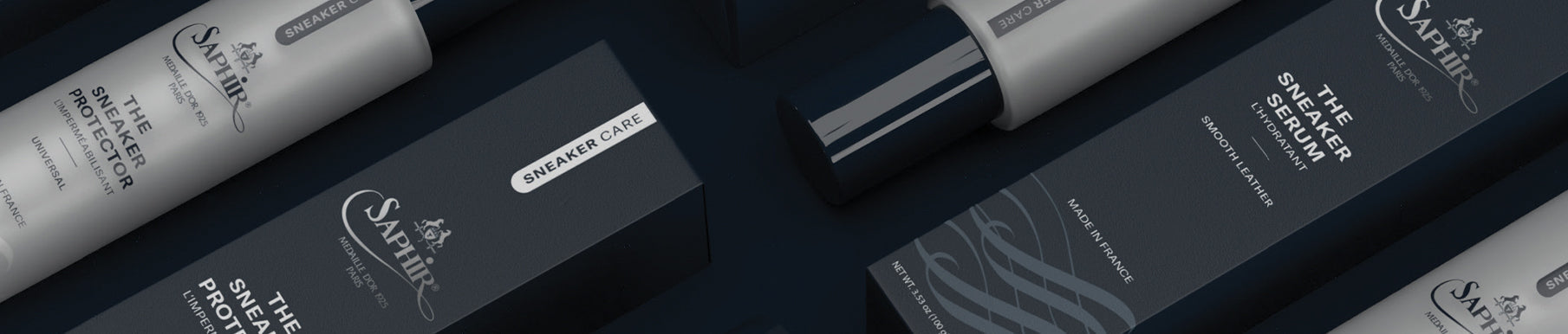 A pair of black shoes and a brush on a black surface.