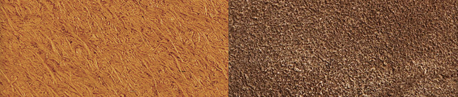 A pair of black shoes and a brush on a black surface.