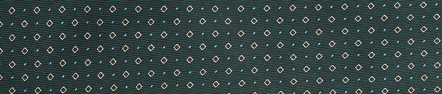 A dark green fabric with a diagonal pattern of small, white, geometric shapes evenly distributed across the surface.