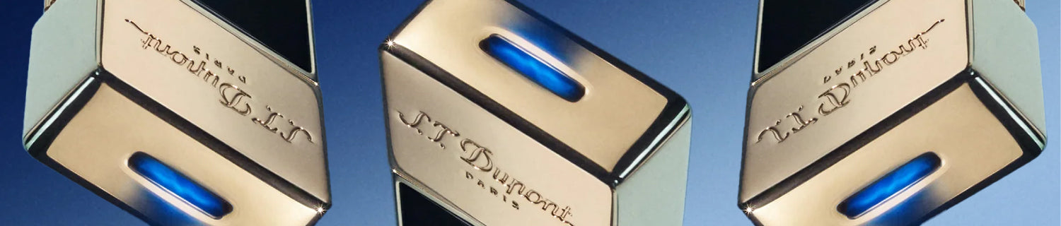 Metallic S.T. Dupont lighters with blue accents and engraved logos against a gradient blue background.