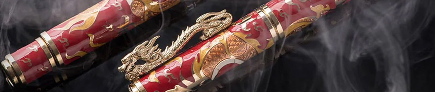 Two ornate red pens with gold dragon designs surrounded by smoke.
