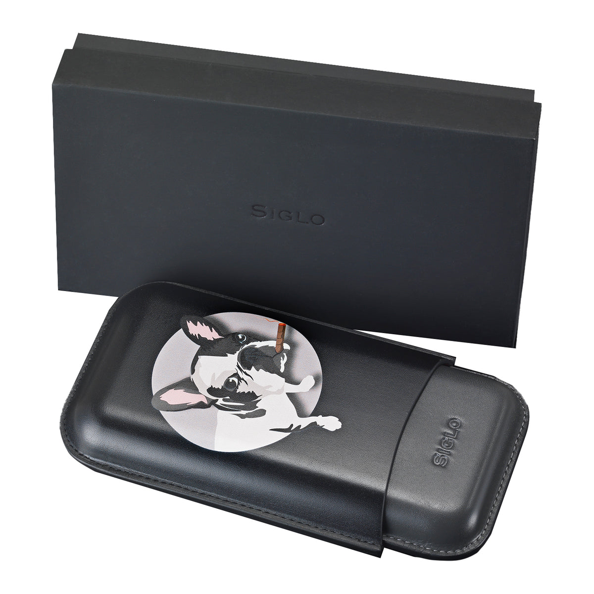 Black leather cigar case with dog illustration medallion on top, accompanied by black box packaging.