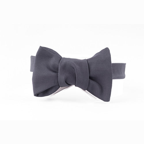 A Sovereign Grade Jumbo Barathea Butterfly Bow Tie from KirbyAllison.com, elegantly showcased on a mannequin, perfect for a formal event.