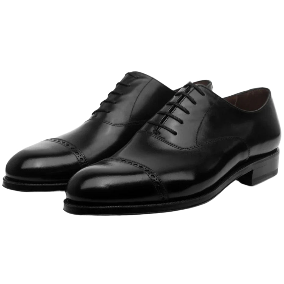 The Punch Cap Oxford from Bridlen, crafted on the Rui last in luxurious black box calf leather with laces and a classic cap-toe design, is perfect for formal occasions.