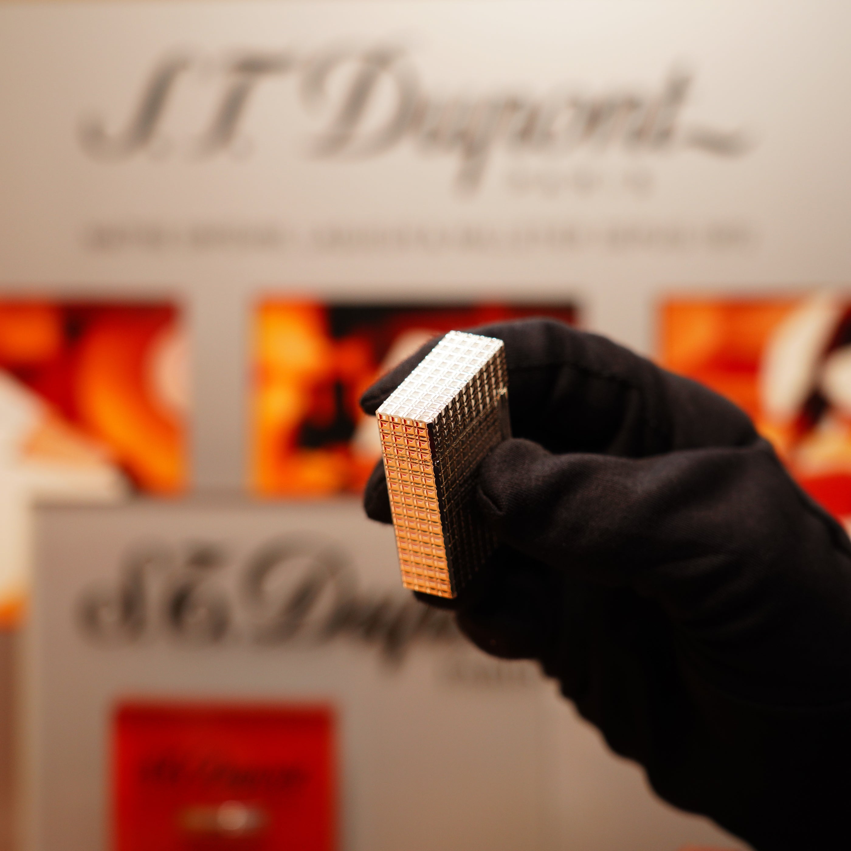 A gloved hand holds a Vintage 1990 S.T. Dupont Iconic Ligne 1 lighter with a heavy silver finish and rare window pattern against a blurred background, showcasing the S.T. Dupont logo.