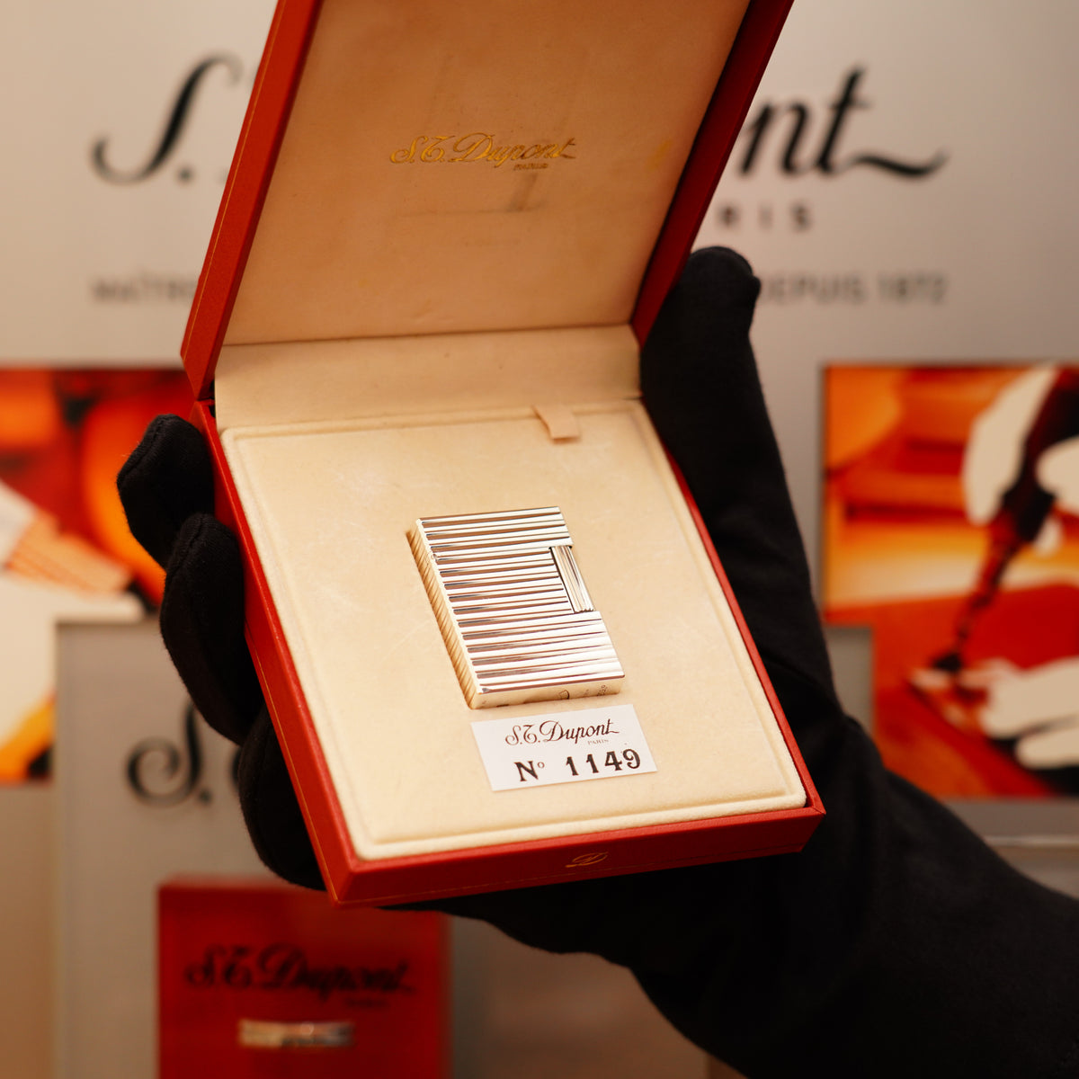 A gloved hand holds an open red box showcasing a Vintage 1996 St Dupont Ligne 1 small Horizontal line heavy silver finish lighter, labeled "S.T. Dupont.