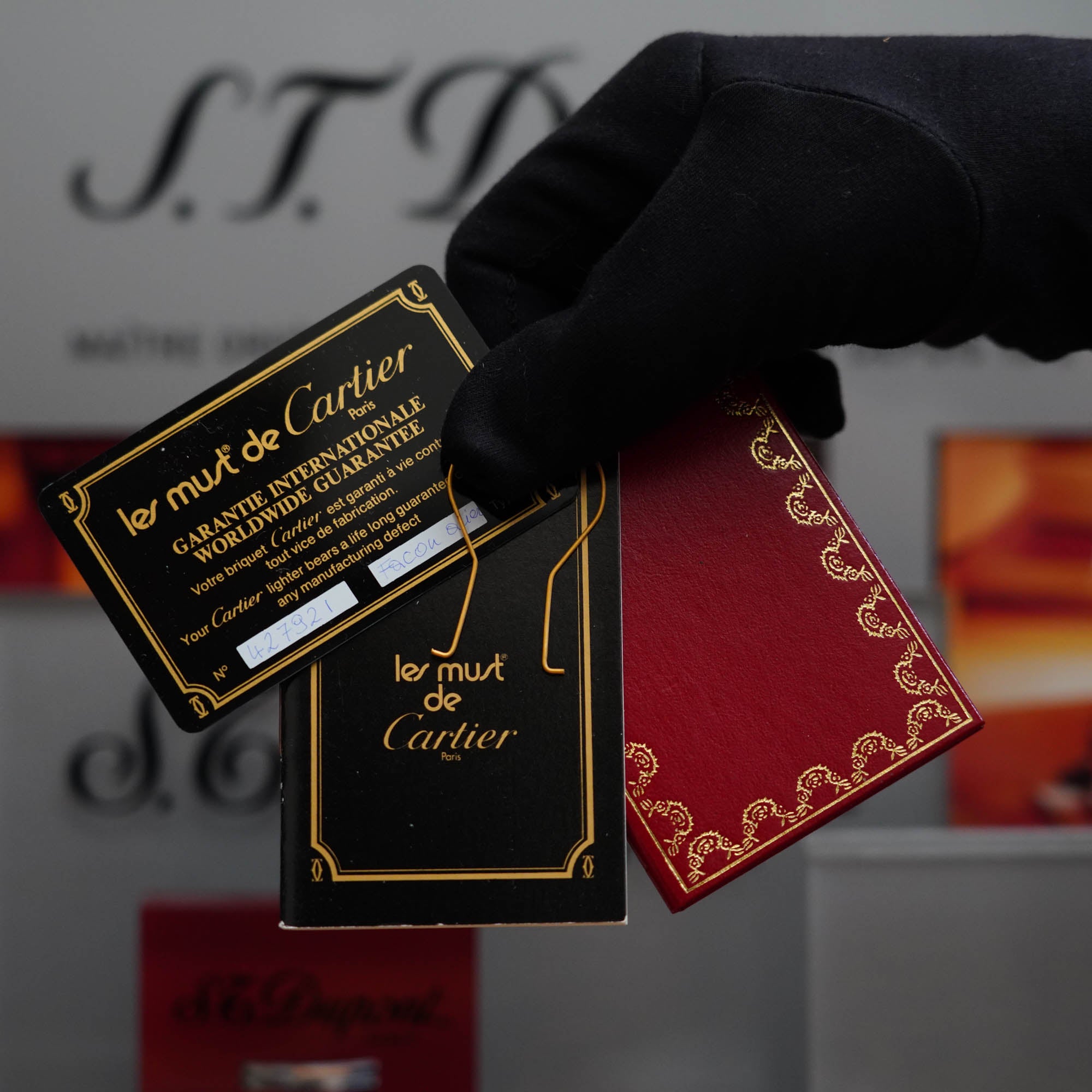 A person is holding a vintage Cartier gift card.