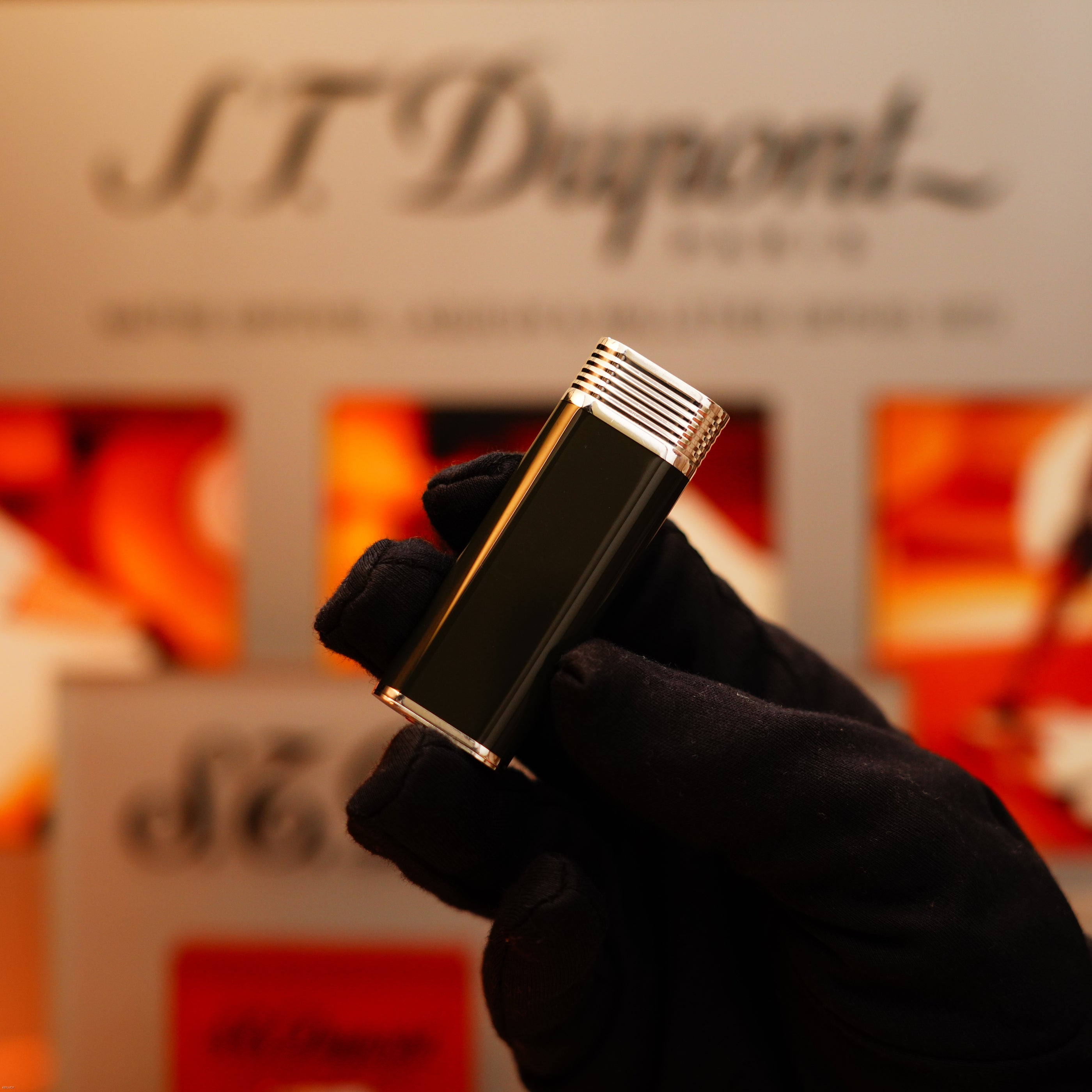 A gloved hand holds a Vintage 1970 Extremely Rare Cartier Solid 925 Sterling Silver Natural Full Dark Green Lacquer Lighter from KirbyAllison.com, set against a blurred background.