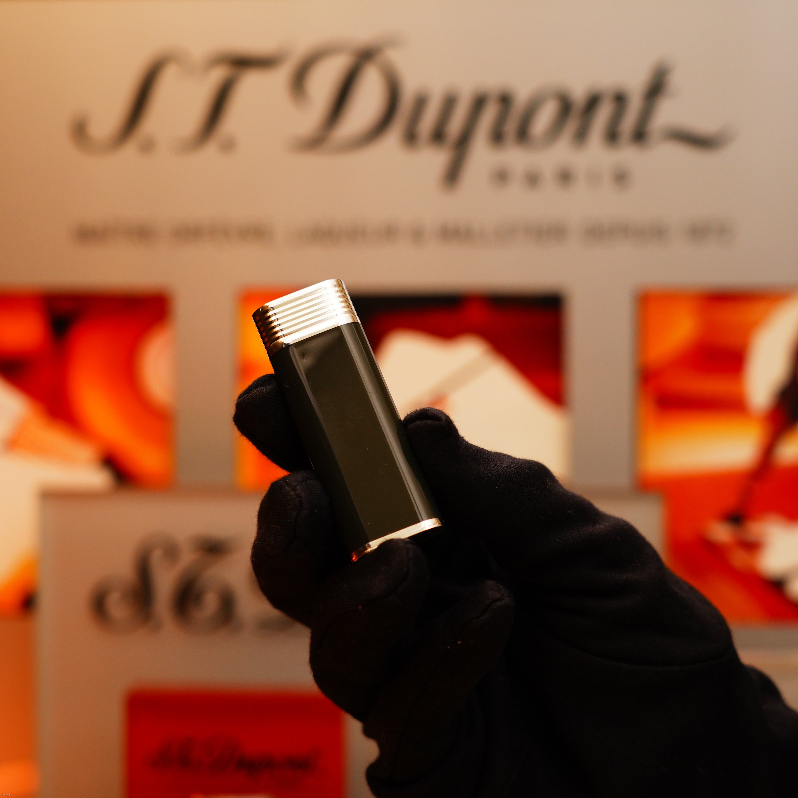 A gloved hand holds a Vintage 1970 Extremely Rare Cartier Solid 925 Sterling Silver Natural Full Dark Green Lacquer Rare Lighter from KirbyAllison.com in front of a display background.