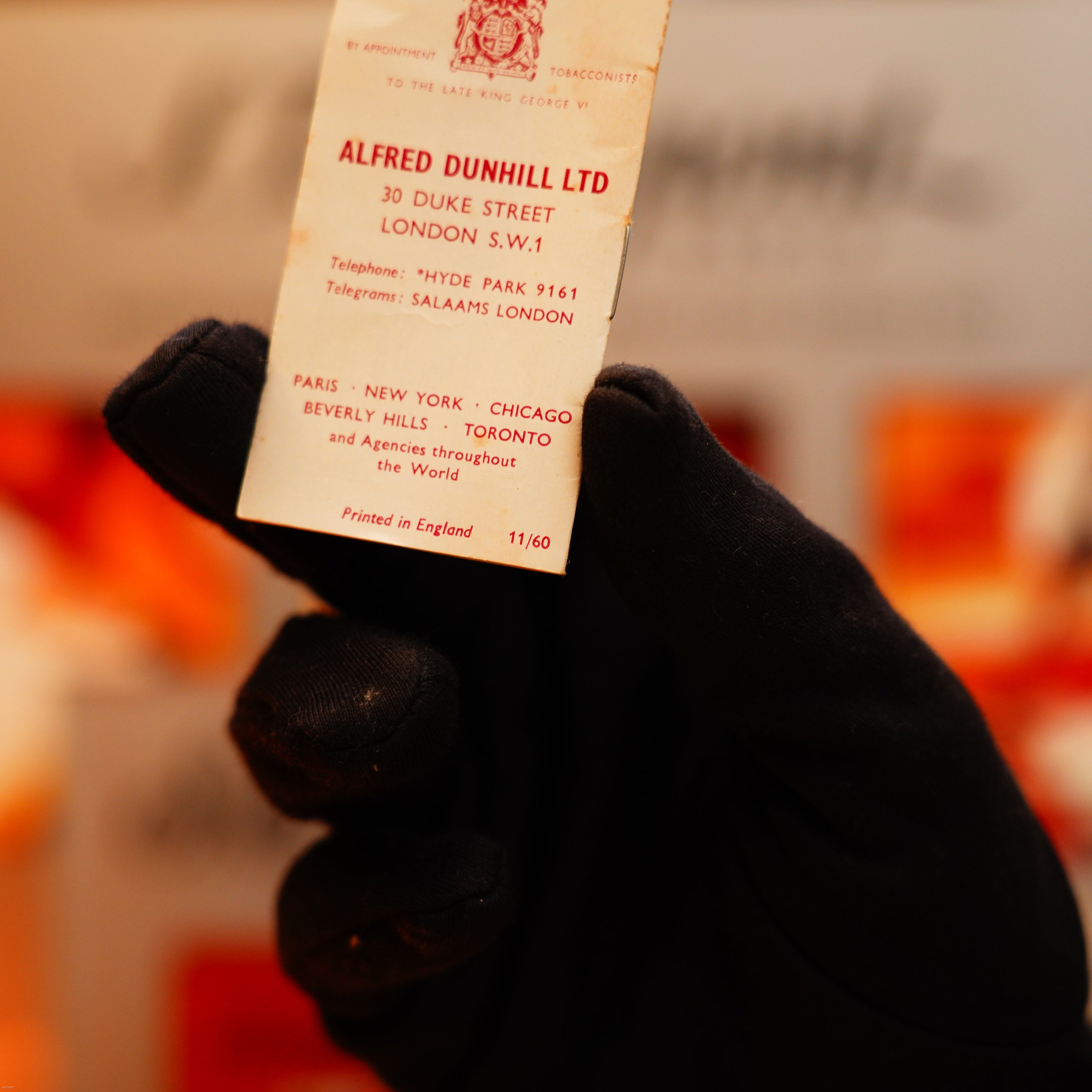 A gloved hand holds a Dunhill Vintage 1964 Rollagas solid 18k gold lighter, marked with the 750 hallmark—an extremely heavy early production piece from the renowned brand.