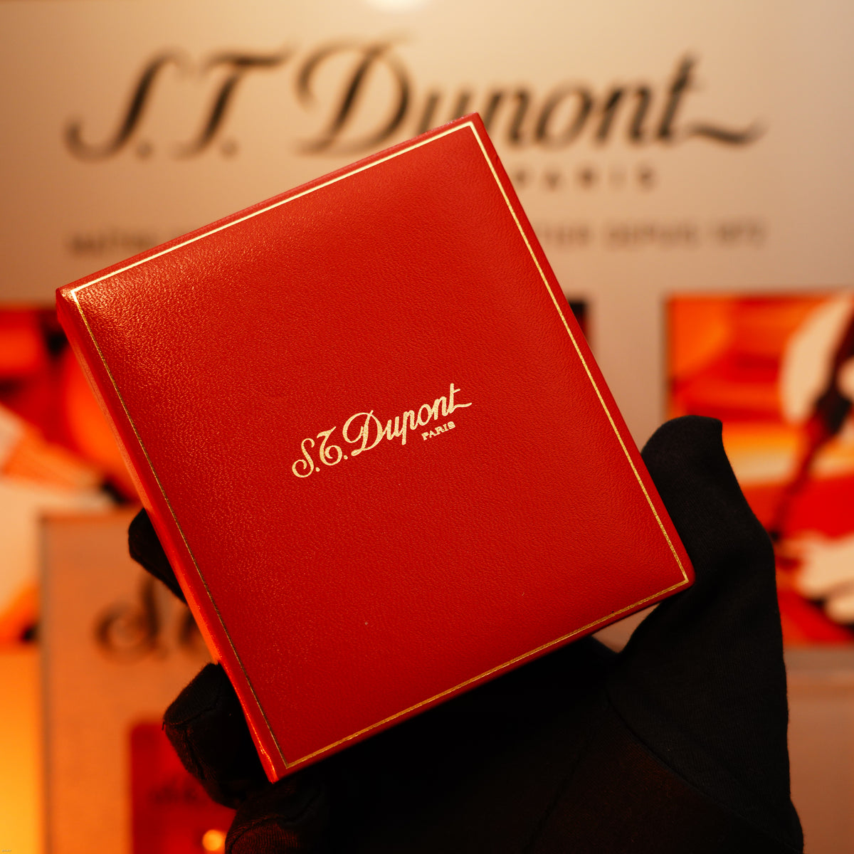 A gloved hand holds a Vintage 1993 St Dupont Europe Rare 24k Gold Finish Blue Lacquer Limited Edition Ligne 2 Lighter by Lucy Lighter, highlighting its elegant design and legacy of quality craftsmanship.