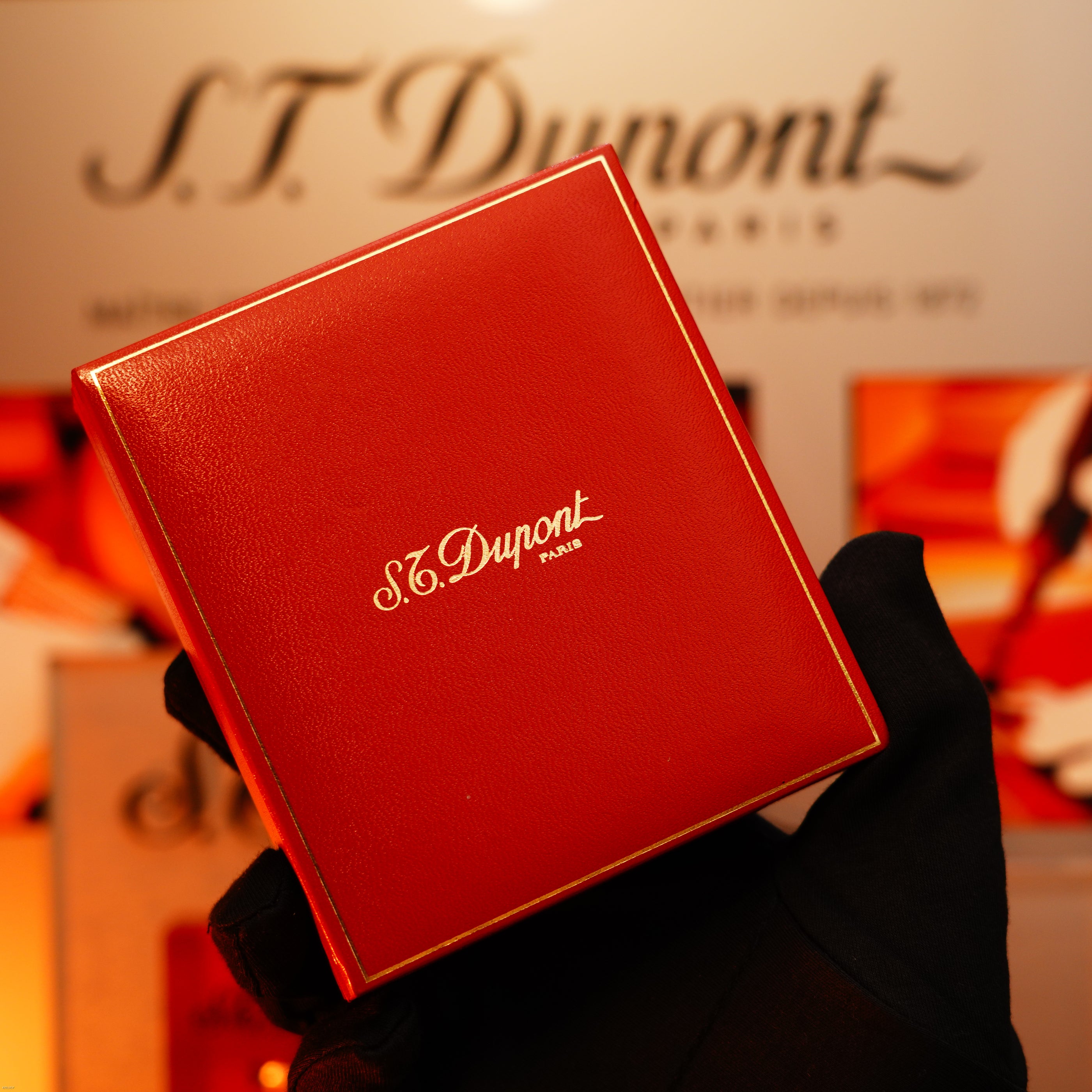 A gloved hand holds a Vintage 1993 St Dupont Europe Rare 24k Gold Finish Blue Lacquer Limited Edition Ligne 2 Lighter by Lucy Lighter, highlighting its elegant design and legacy of quality craftsmanship.