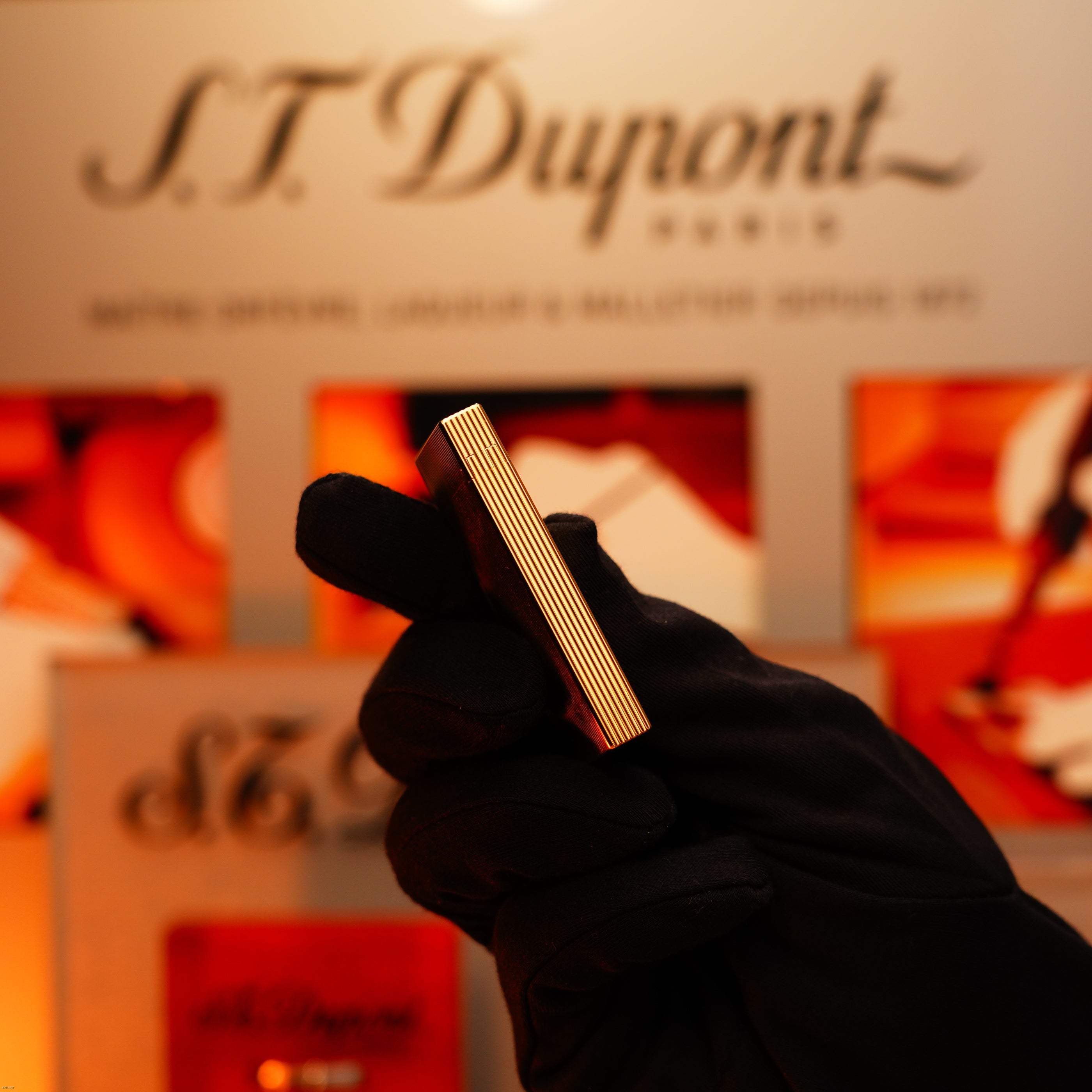 A gloved hand holds the Vintage 1970 Heavy 24k Gold Finish Caran d'ache Limited Madison Swiss Lighter by Lucy Lighter, an extremely rare piece that exudes vintage luxury and includes a 12-month warranty against functional issues.