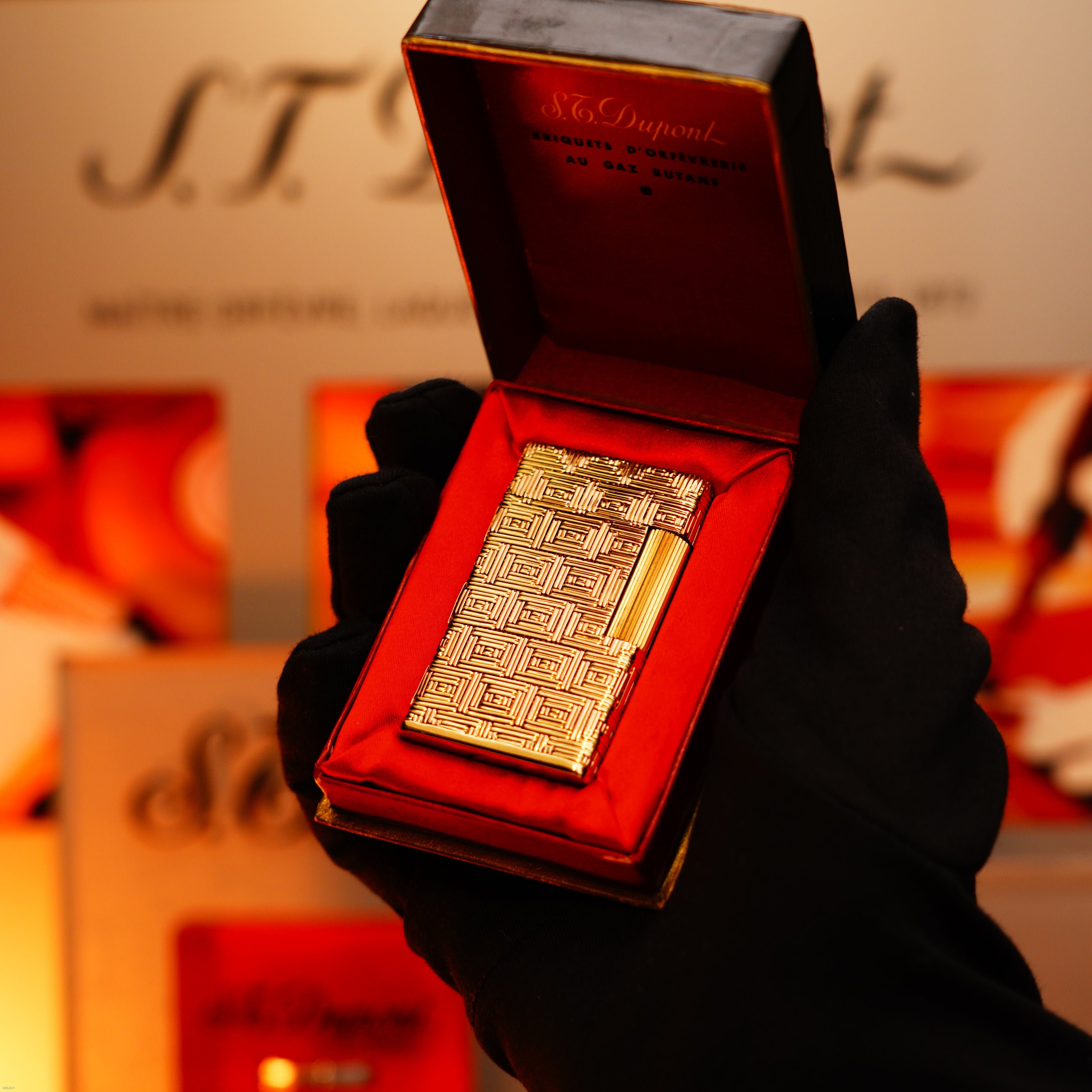 A gloved hand holds a Vintage 1960 Extremely Rare 1/1 St Dupont Lighter—solid 18K gold, heavy early edition, 750 hallmarked—by Lucy Lighter, nestled in a red velvet case with branded packaging and working warranty.