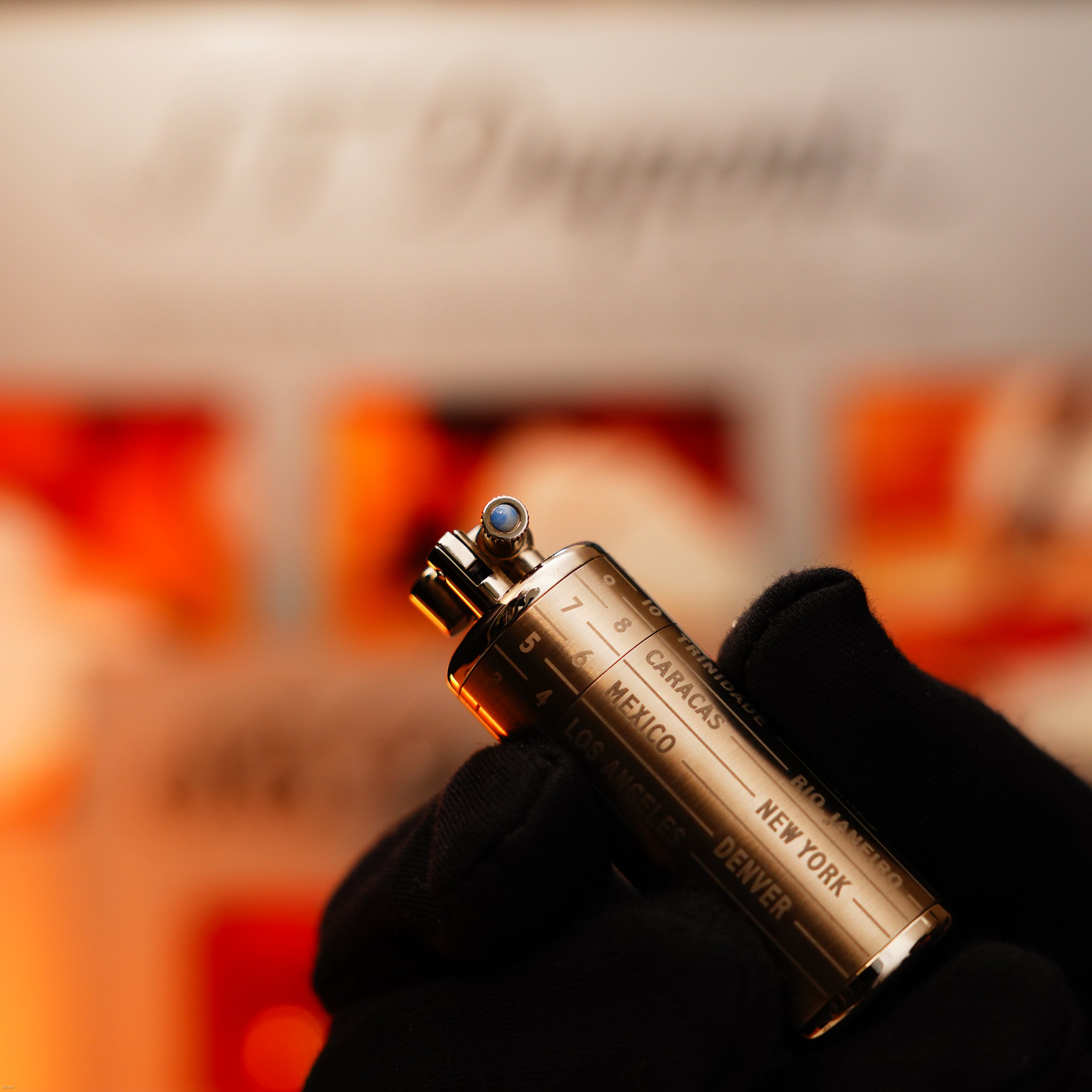 A gloved hand holds a Vintage Extremely Rare Alfred Dunhill Full Set GMT Solid Stainless Steel Lucy Lighter, engraved with city names like New York, Mexico, and Caracas. Includes a 12-month warranty for peace of mind.