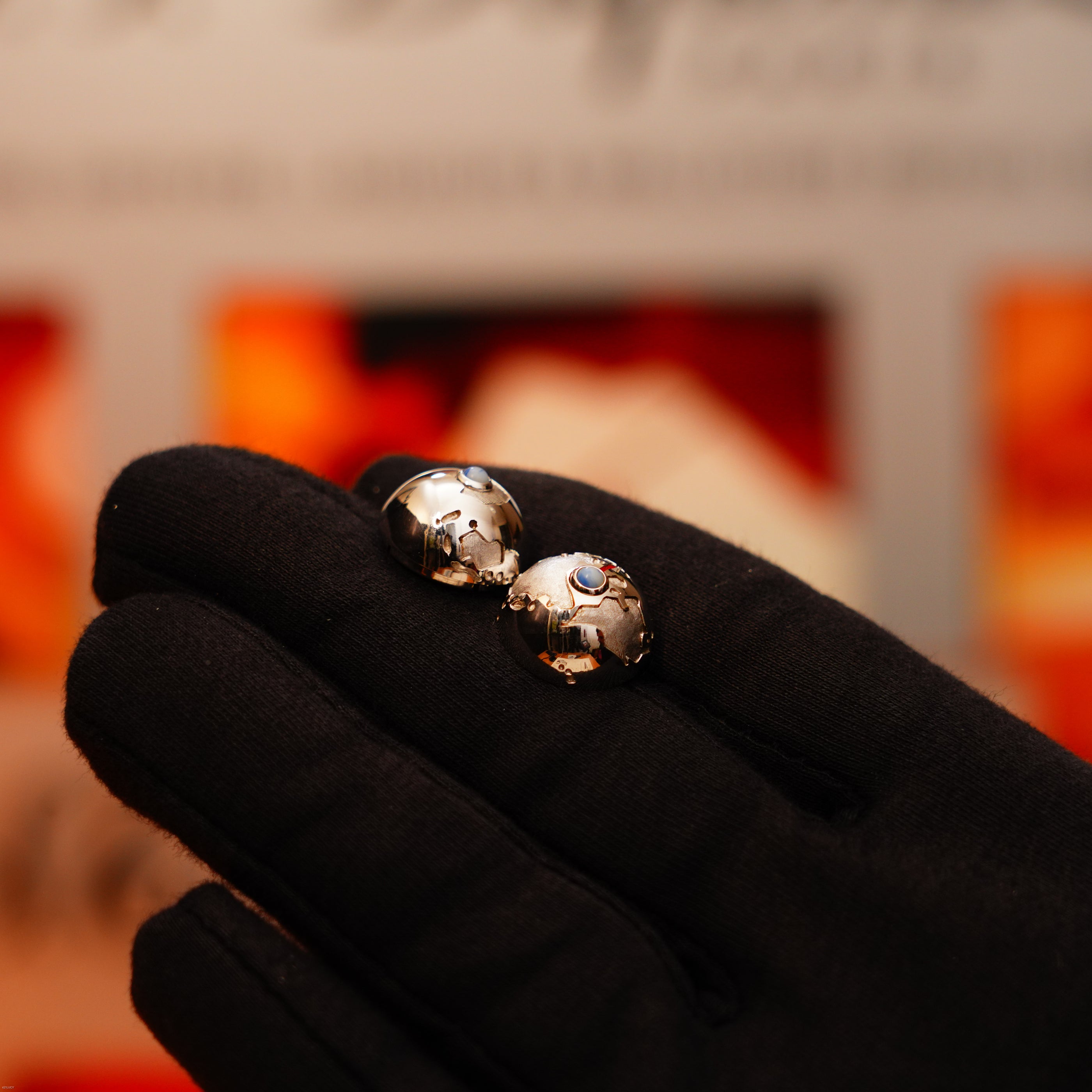 A gloved hand holds two gleaming Alfred Dunhill Signature Lucy Lighters—vintage, extremely rare, full solid stainless steel GMT models—an elegant full set that includes a 12-month warranty for your peace of mind.