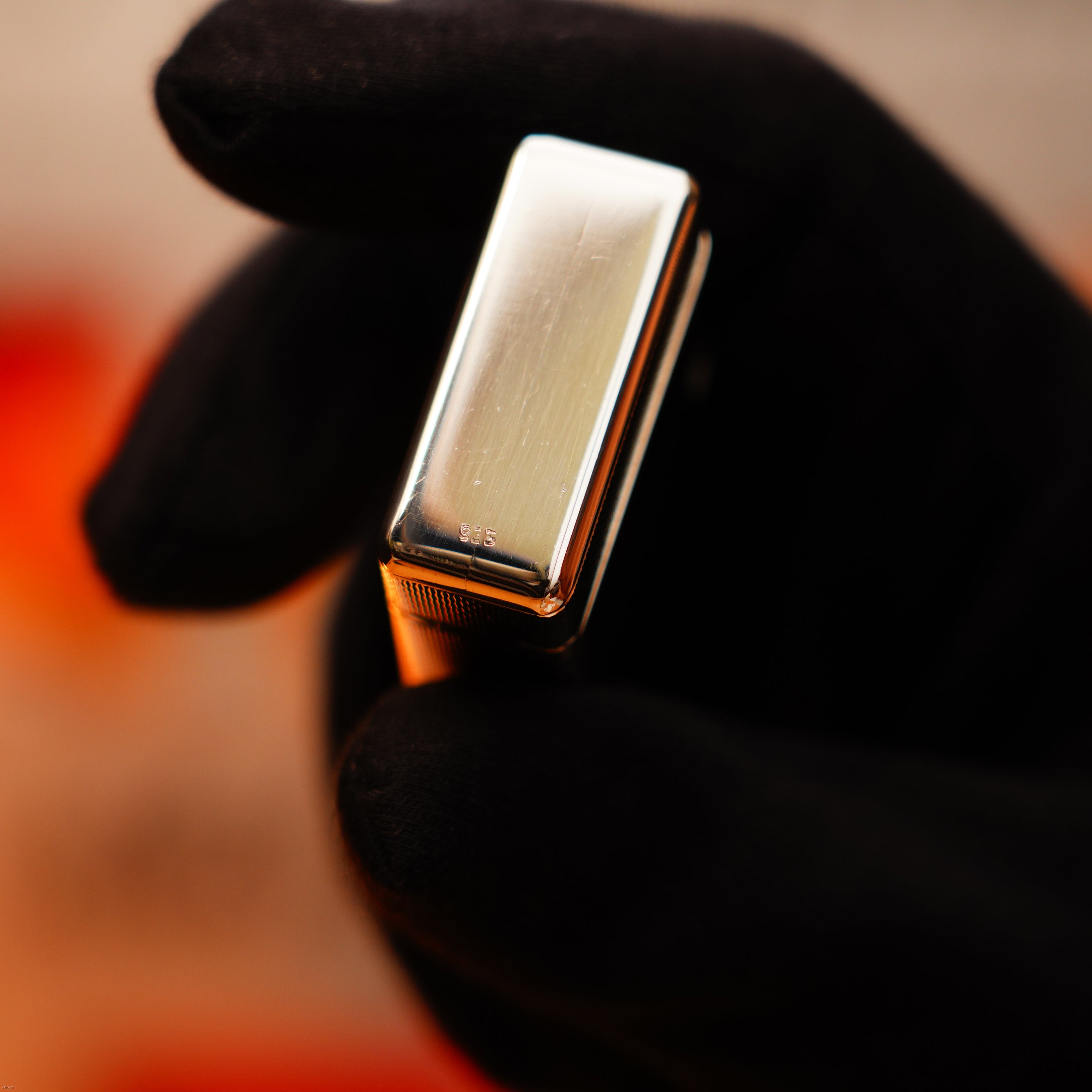 A gloved hand holds the Lucy Lighter Vintage 1970 1/1 De St Dupont Solid 925 Sterling Ligne 1 Heavy Barley Pattern Lighter, marked "925" to signify its rare, high-quality craftsmanship.