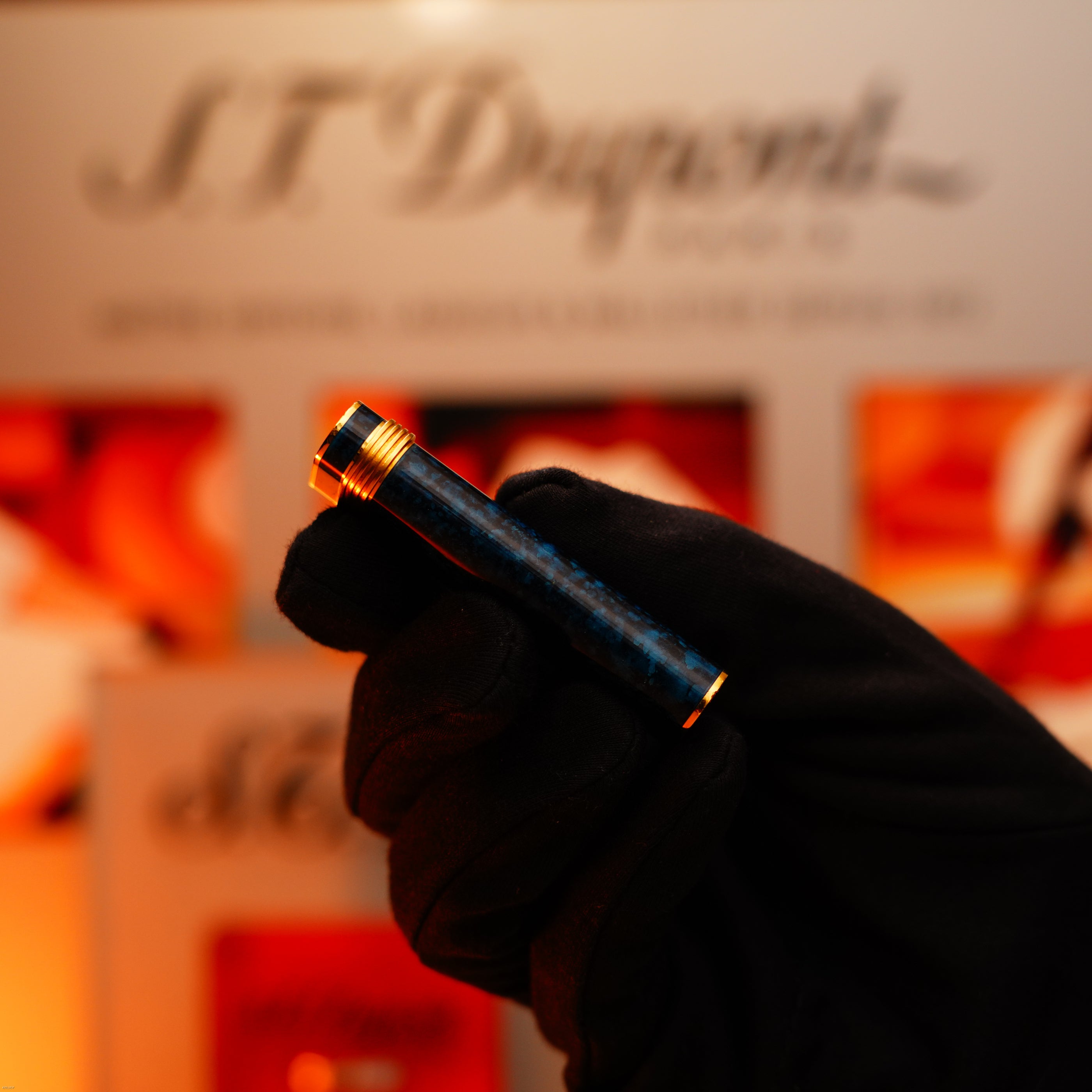 A gloved hand holds the Vintage 1980 Cartier Oval 24k Gold Finish Lapiz Lacquer with 18k Trinity Ring On Door Le Must Lighter by Lucy Lighter, showing the brand’s dedication to luxury craftsmanship and enduring quality.