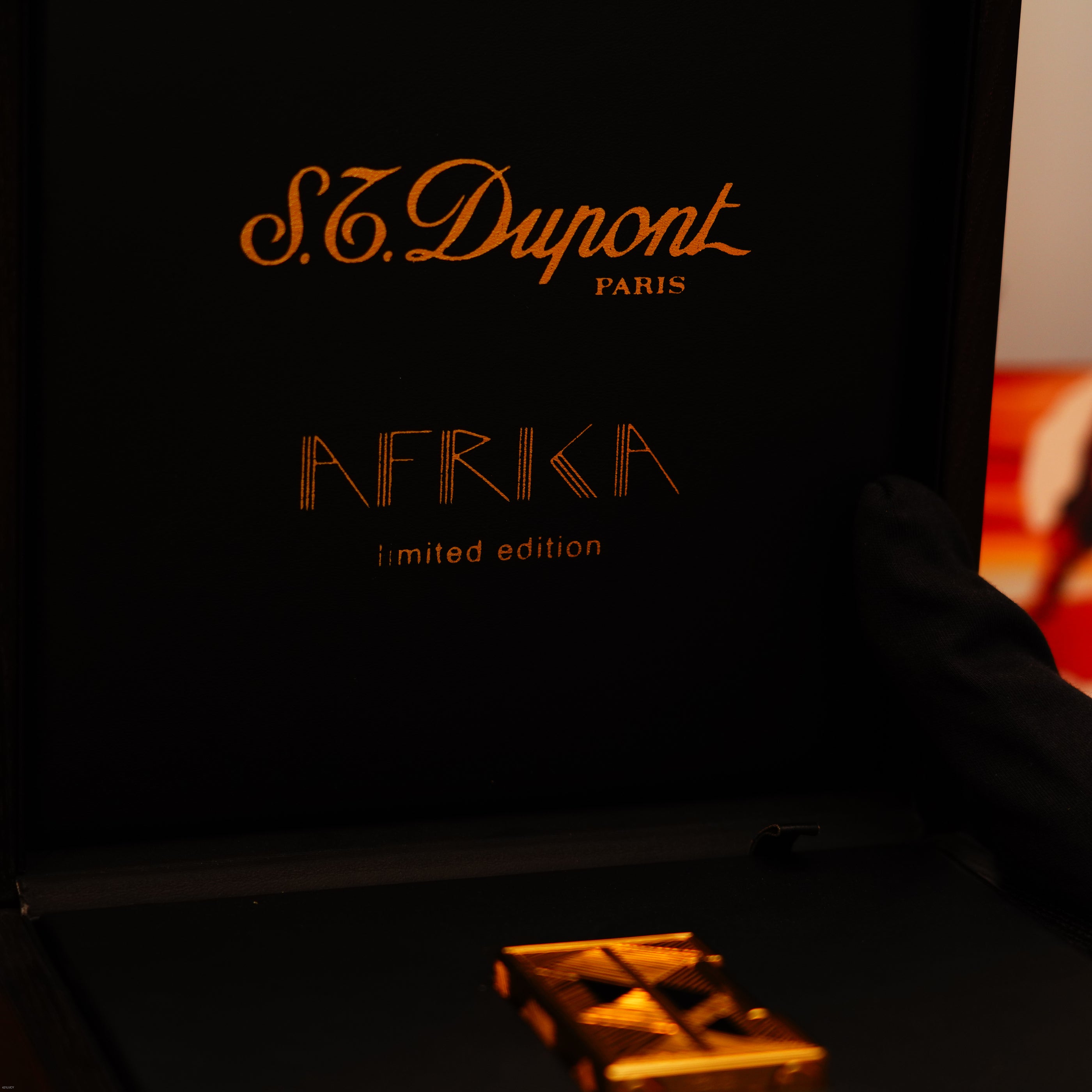 A black box with gold accents shows "Lucy Lighter," "Vintage 2000 St Dupont Limited Edition Heavy 24k Gold Finish Africa Natural Lacquer Large Ligne 2 Lighter" inside—luxury and authenticity at a glance.