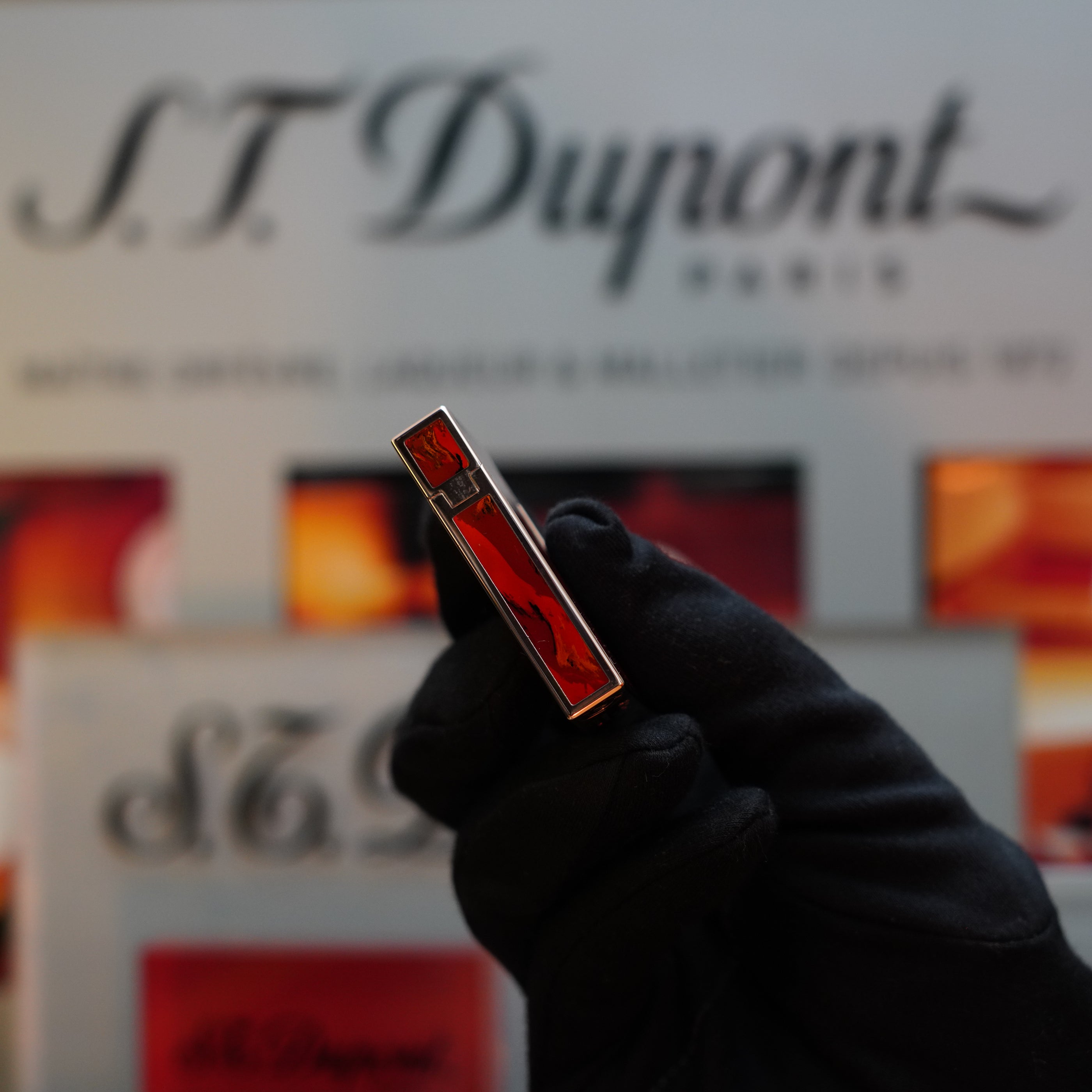 A gloved hand holds the 1970 S.T. Dupont Picaso 24k Rose Gold Ligne 2 Natural Lacquer rare ligne 2 Lighter, with the S.T. Dupont logo and packaging visible in the background—a true collector's item.