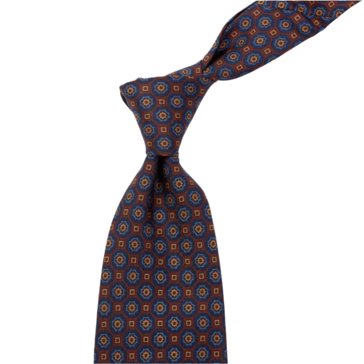 A Sovereign Grade Rust/Blue Floral Medallion Ancient Madder Tie, inspired by the colors of the United Kingdom, made by KirbyAllison.com.