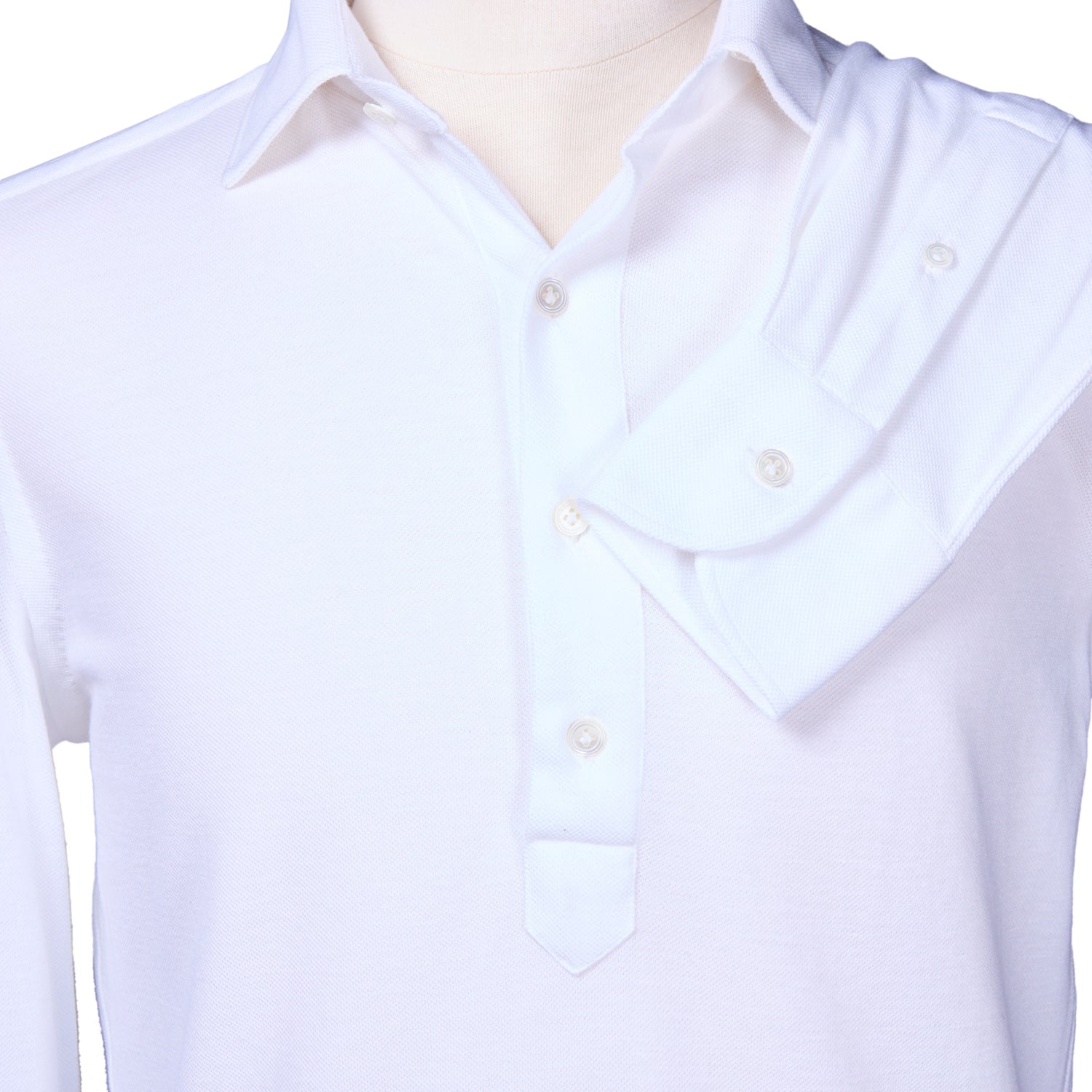 Close-up of a white long sleeve knit polo on a mannequin, with one sleeve draped over the shoulder, showcasing the refined craftsmanship of 100 Hands x Kirby Allison from KirbyAllison.com.