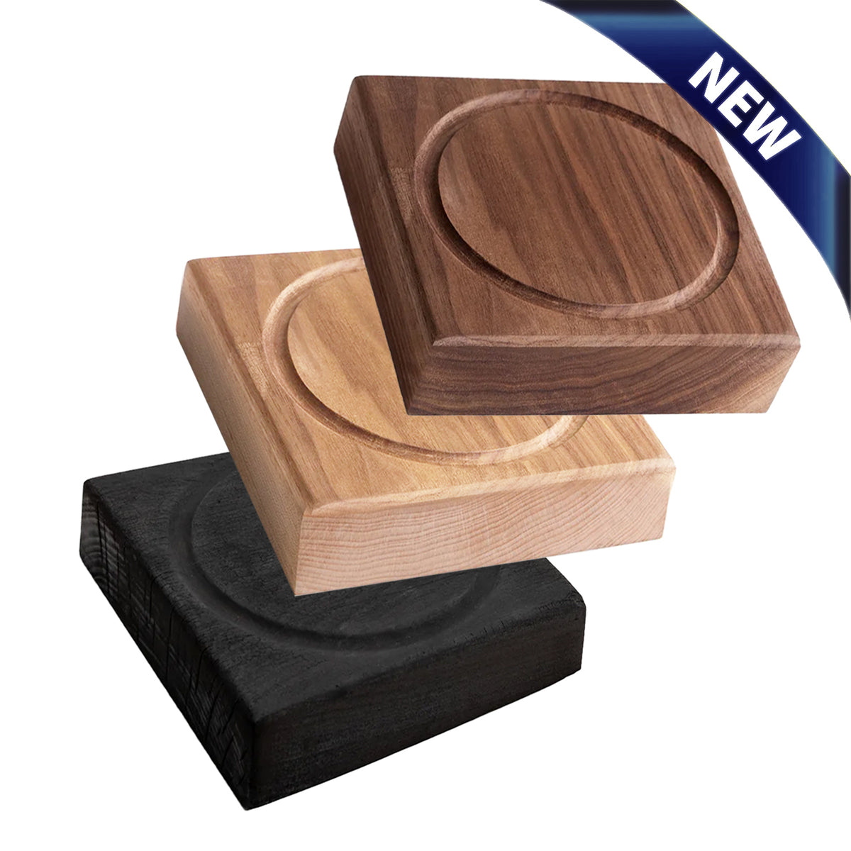 Three square wooden coasters or trivets with circular recessed centers, shown in dark brown, light natural wood, and black wood finishes on a white background, with a blue 'NEW' ribbon in the top right corner.